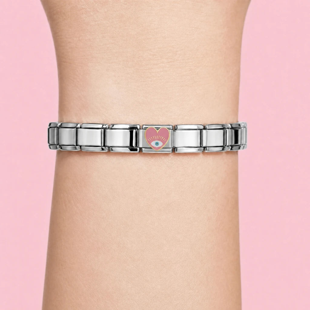 Pink Eye Heart charm worn on a silver Italian bracelet