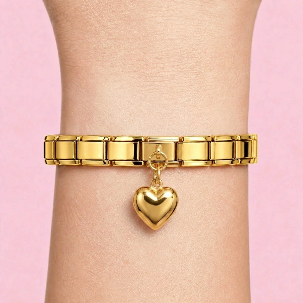 Puffed heart dangle charm worn on a gold Italian bracelet
