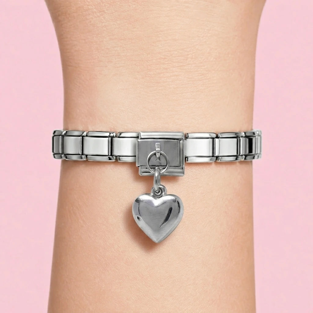 Puffed heart dangle charm worn on a silver Italian bracelet