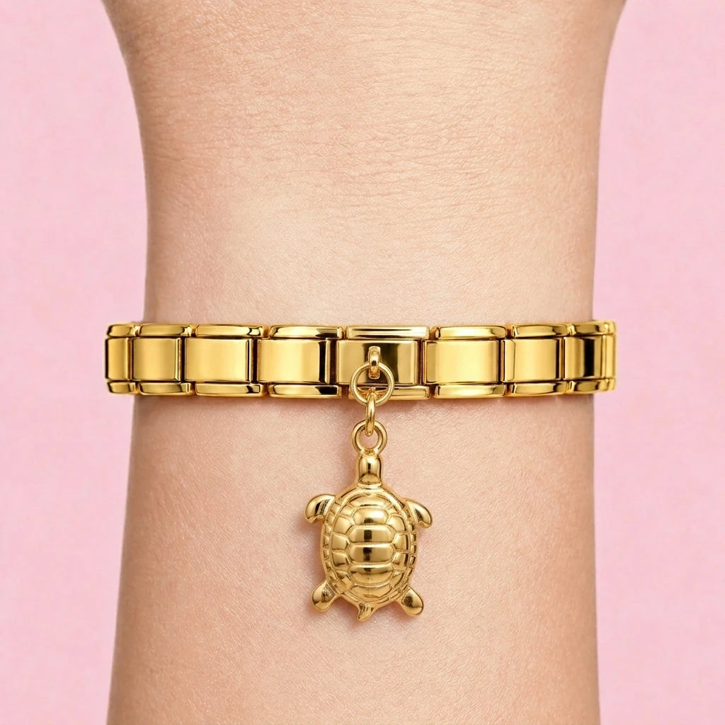 Sea turtle dangle charm worn on a gold Italian bracelet