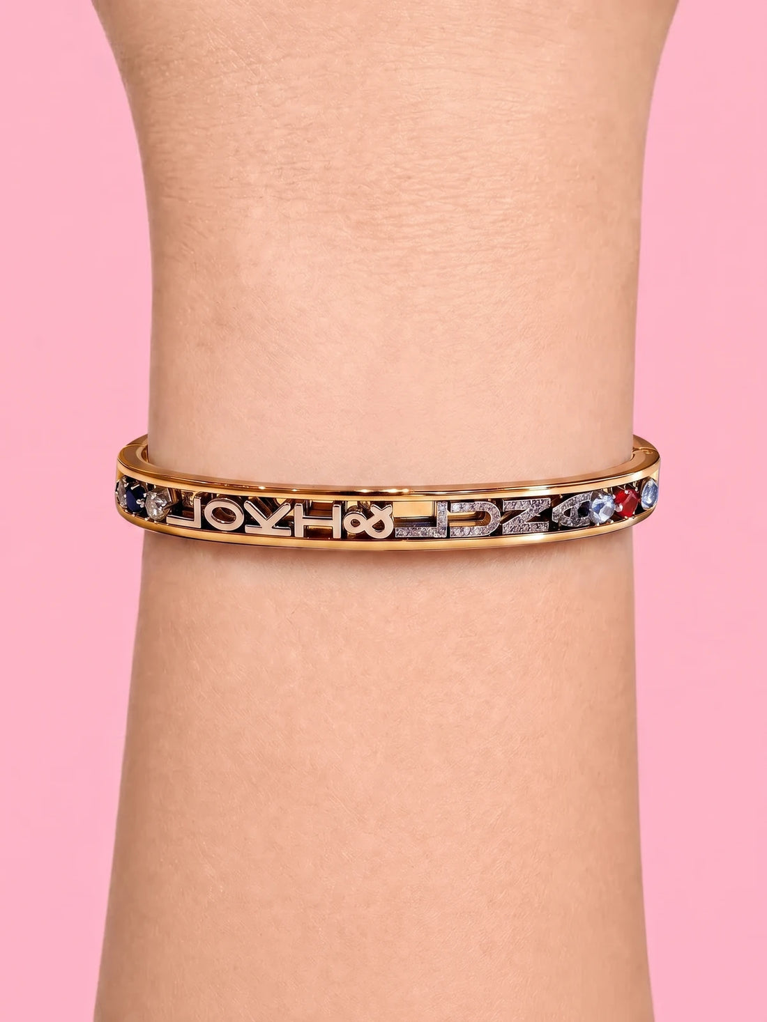 Gold charm bangle on the wrist