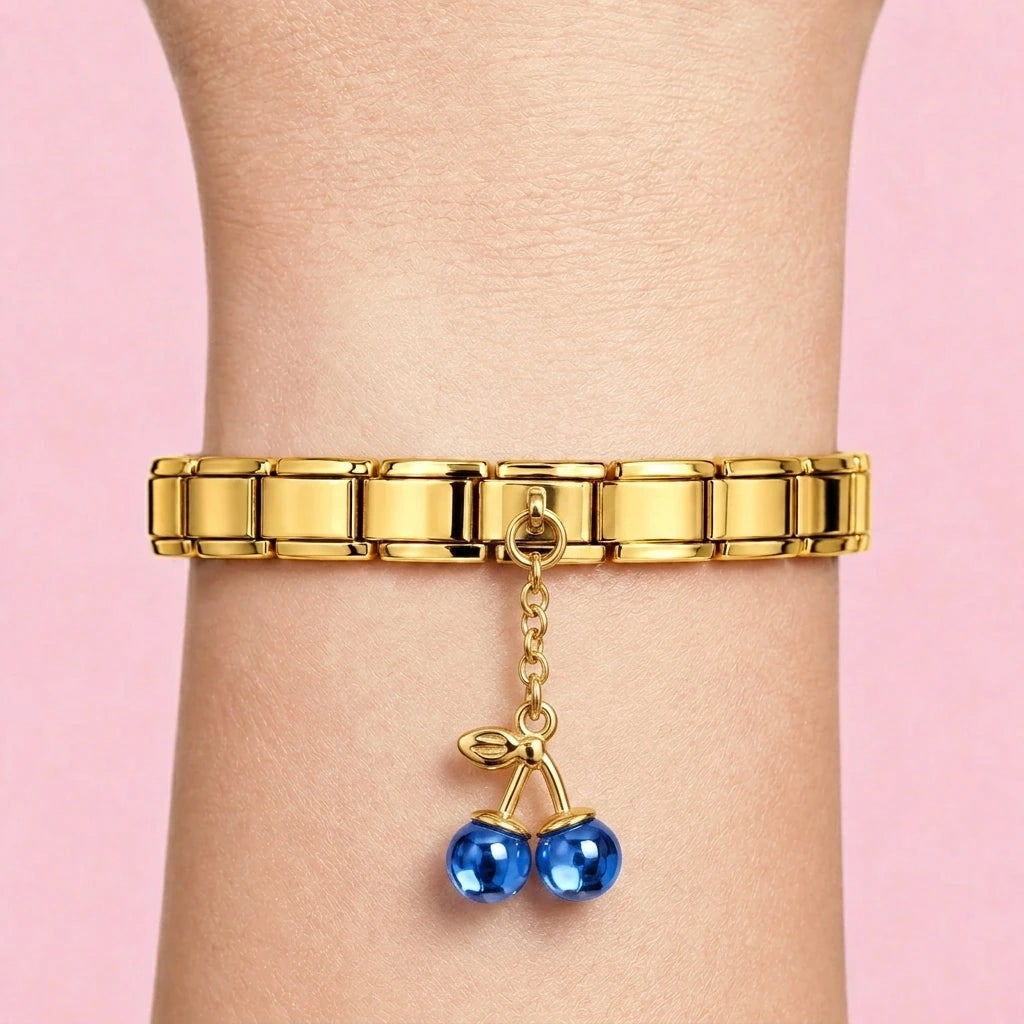 Blue cherry dangle charm worn on a gold Italian bracelet