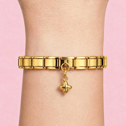 Cross dangle charm worn on a gold Italian bracelet