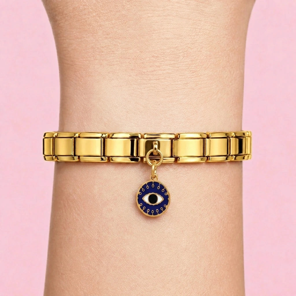 Deep blue evil eye dangle charm worn on a gold Italian bracelet