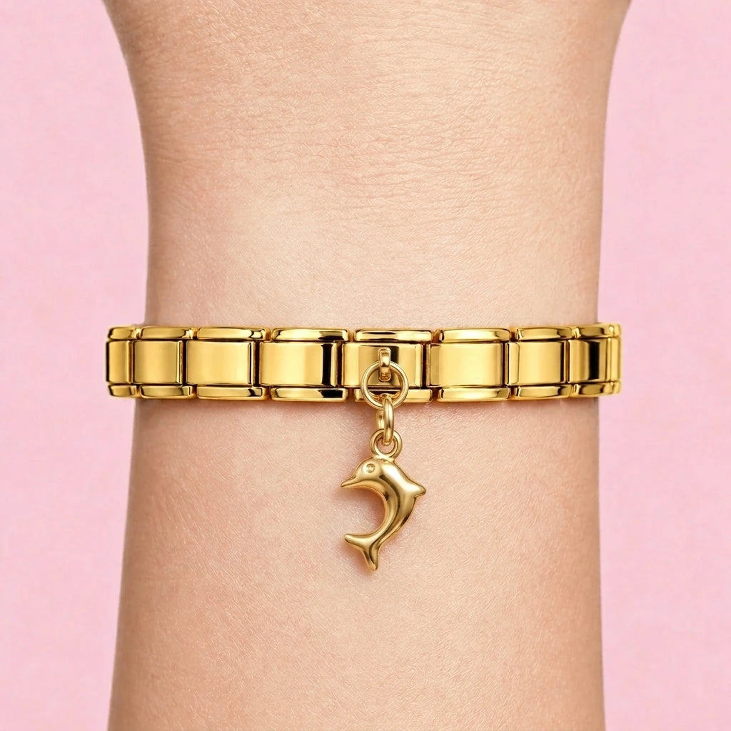 Dolphin dangle charm worn on a gold Italian bracelet