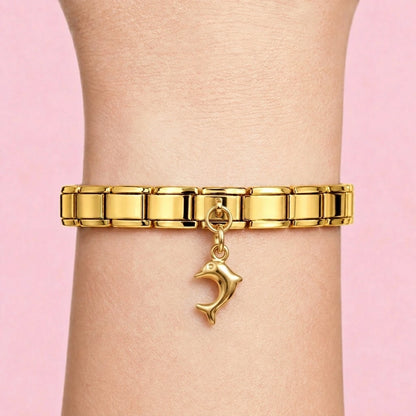 Dolphin dangle charm worn on a gold Italian bracelet