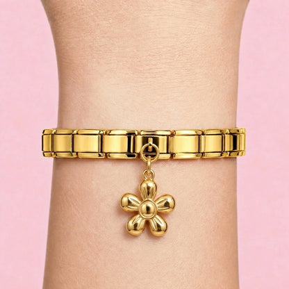 Flower dangle charm worn on a gold Italian bracelet