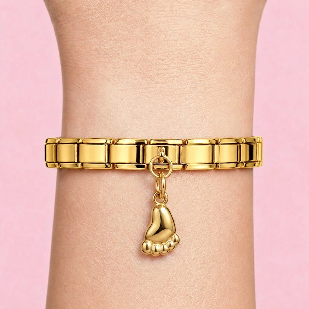 Baby foot dangle charm worn on a gold Italian bracelet
