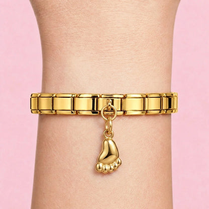 Baby foot dangle charm worn on a gold Italian bracelet