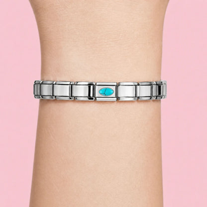 Turquoise Stone charm worn on a silver Italian bracelet