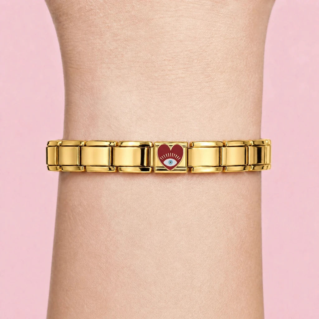 Golden Red Eye Heart charm worn on a gold Italian bracelet