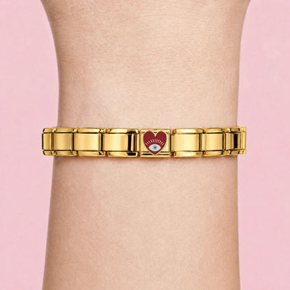 Golden Red Eye Heart charm worn on a gold Italian bracelet