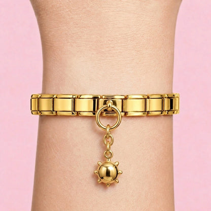 Ladybug dangle charm worn on a gold Italian bracelet
