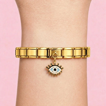 Lash eye dangle charm worn on a gold Italian bracelet
