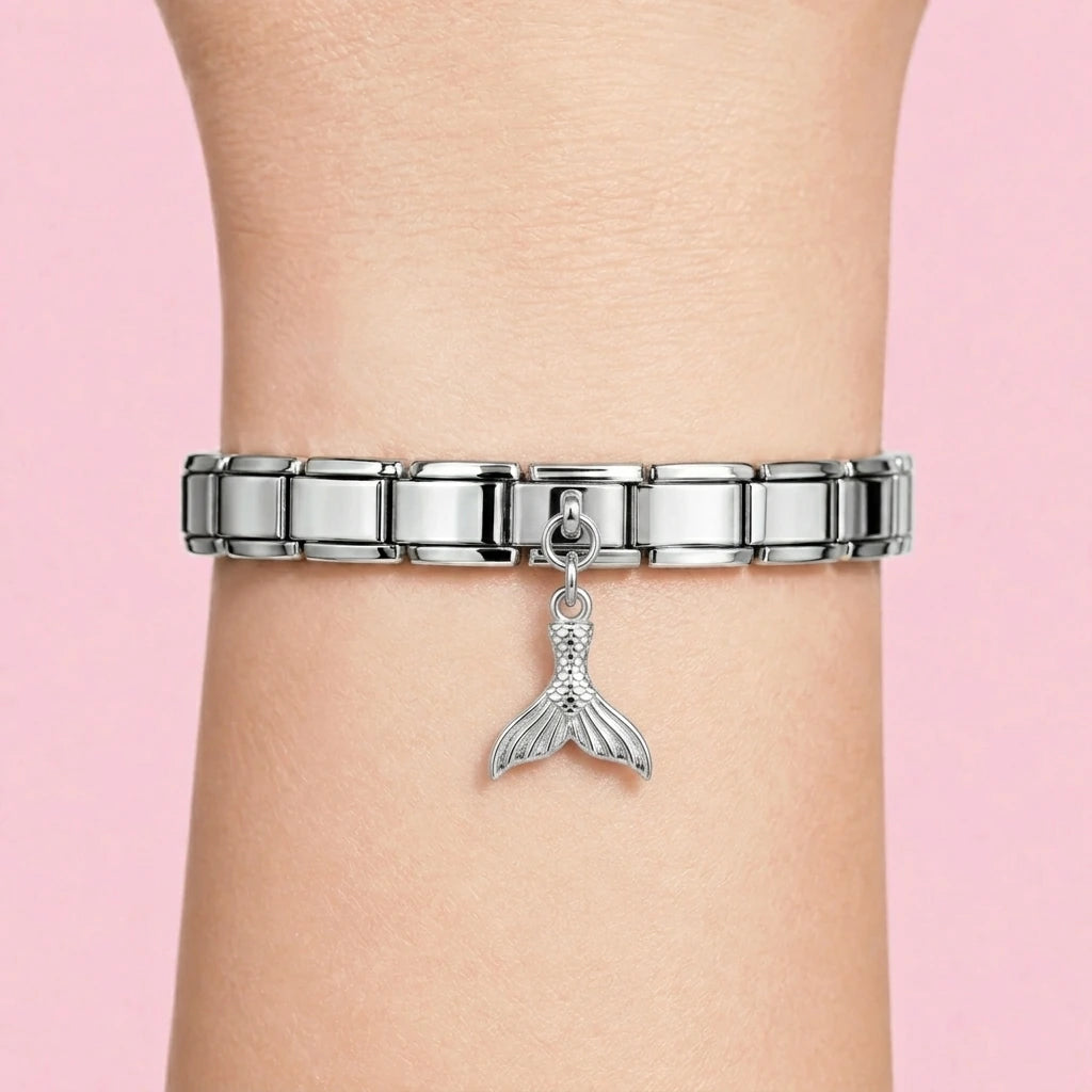 Mermaid tail dangle charm worn on a silver Italian bracelet