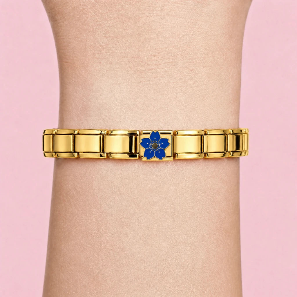 Blue Sakura charm worn on a gold Italian bracelet