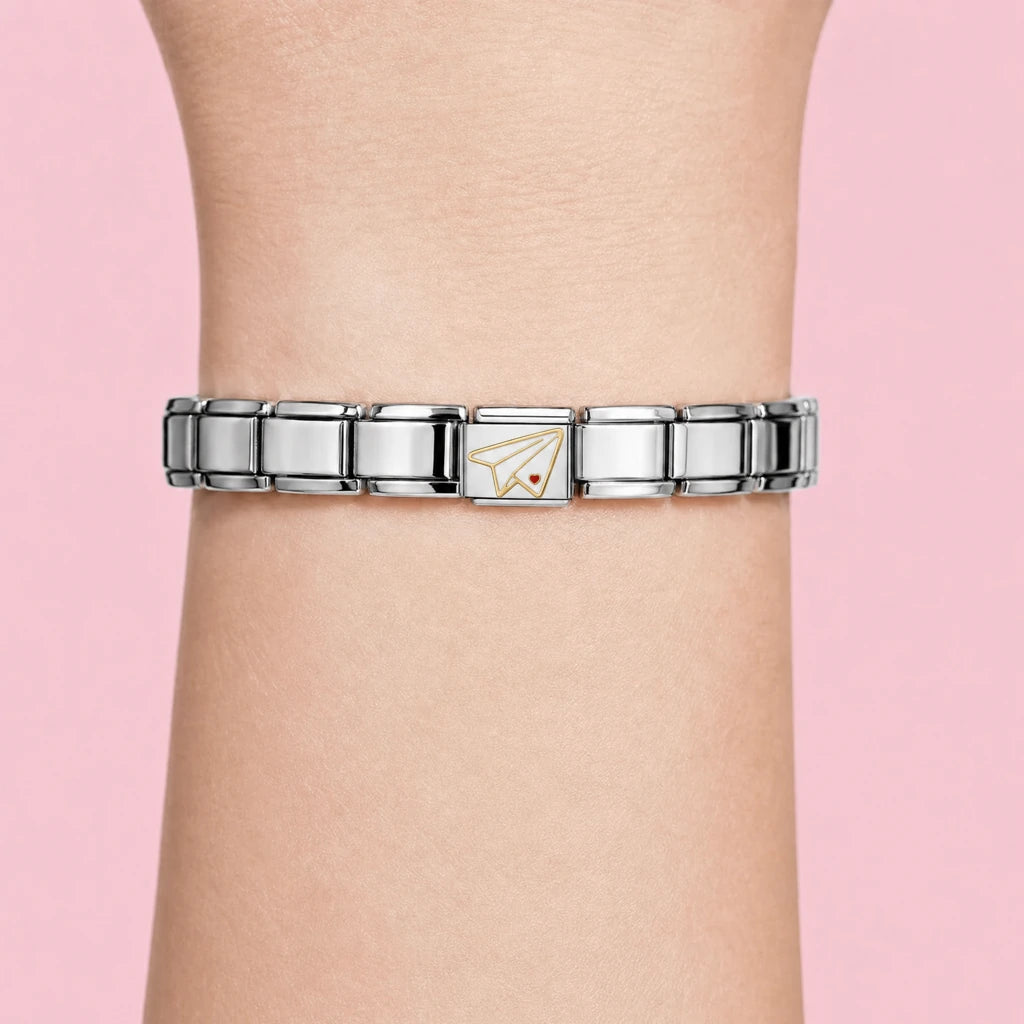 Paper Plane charm worn on a silver Italian bracelet
