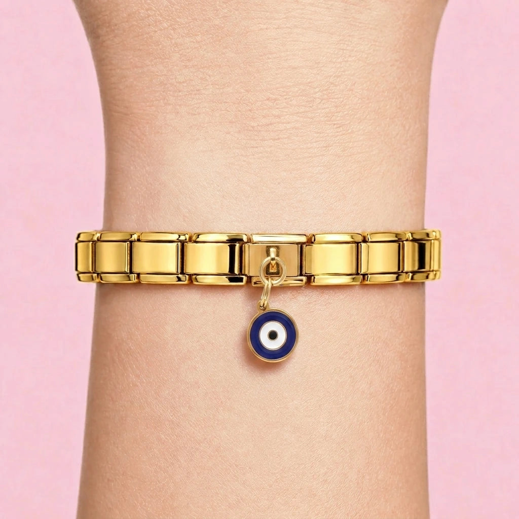 Navy evil eye dangle charm worn on a gold Italian bracelet