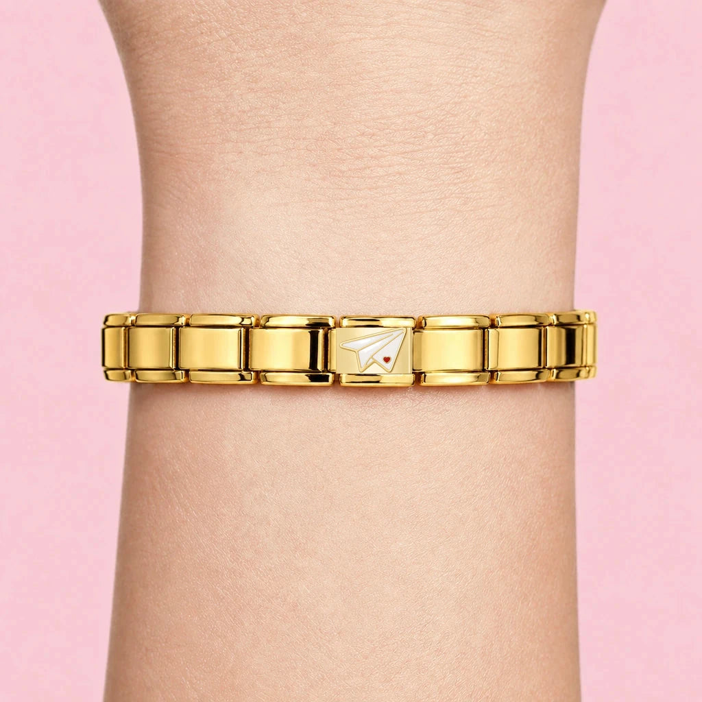 Paper Plane charm worn on a gold Italian bracelet