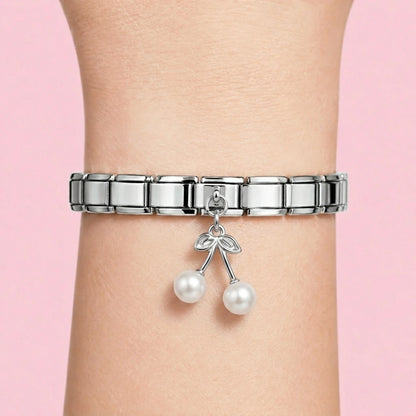 Pearl cherry dangle charm worn on a silver Italian bracelet