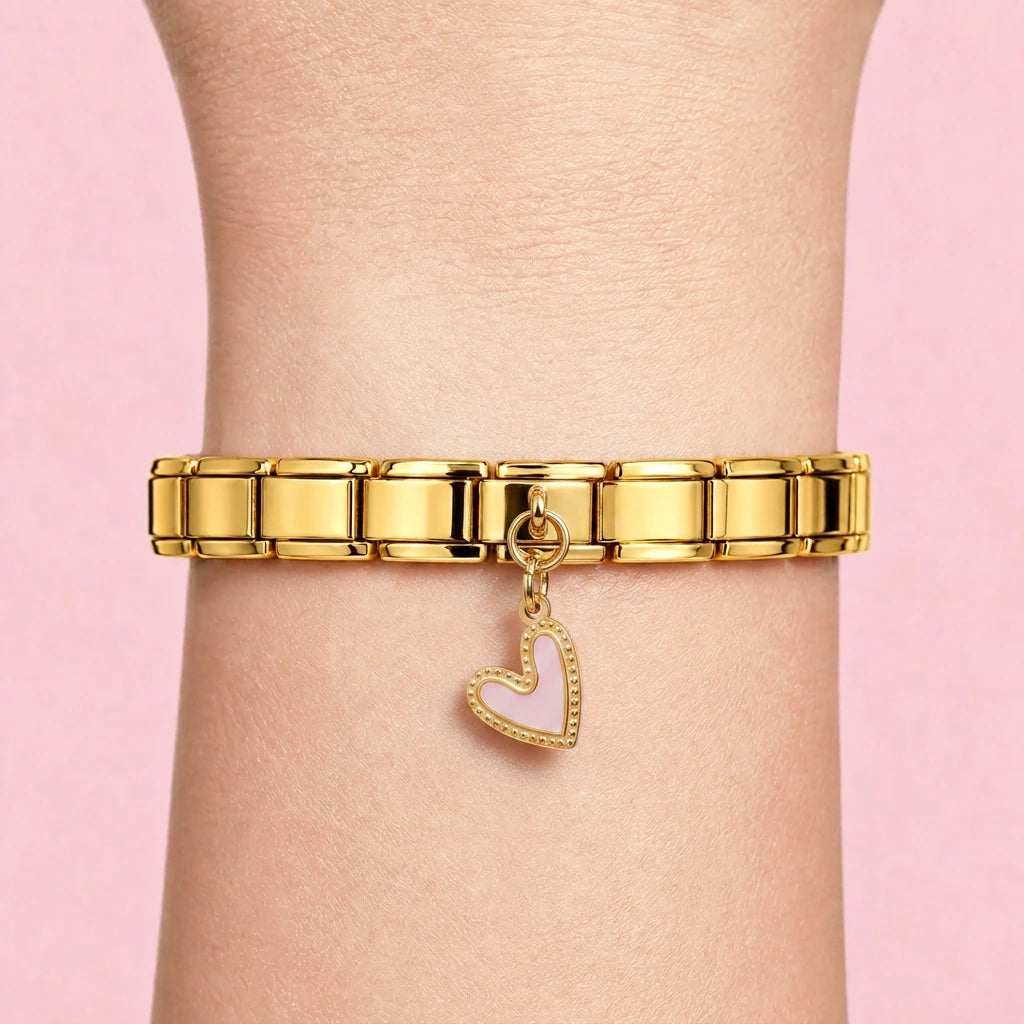 Pink heart dangle charm worn on a gold Italian bracelet