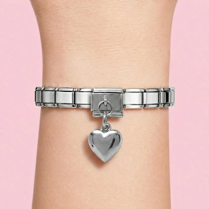 Puffed heart dangle charm worn on a silver Italian bracelet