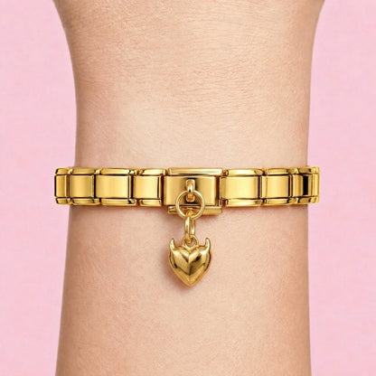 Slim heart dangle charm worn on a gold Italian bracelet