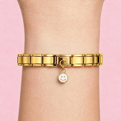 Smiley dangle charm worn on a gold Italian bracelet