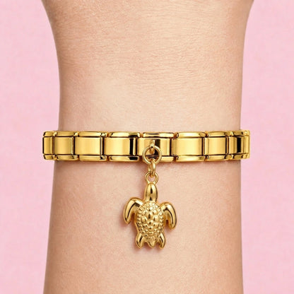 Turtle dangle charm worn on a gold Italian bracelet