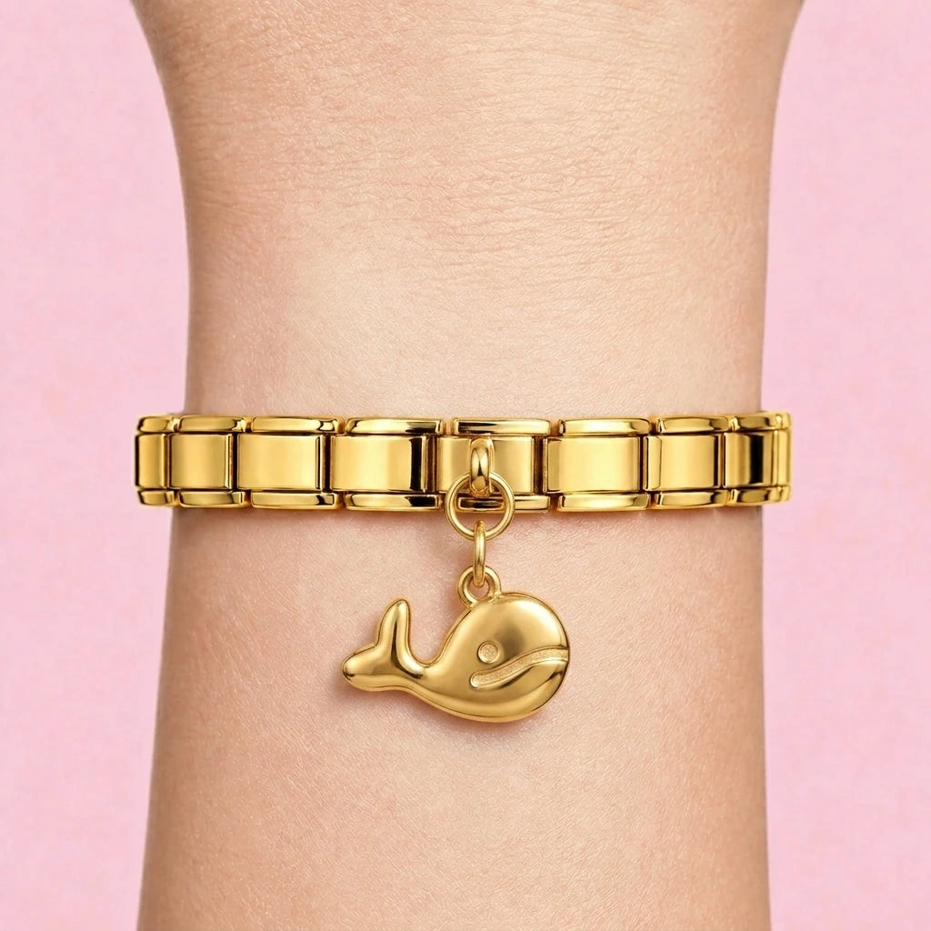 Whale dangle charm worn on a gold Italian bracelet