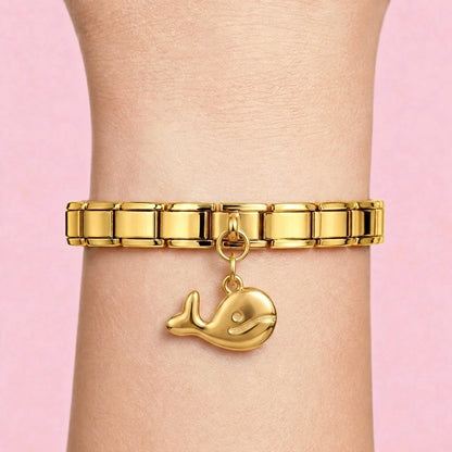 Whale dangle charm worn on a gold Italian bracelet